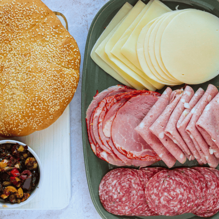 Ingredients needed for Air Fryer Muffaletta Sandwich on kitchen table.