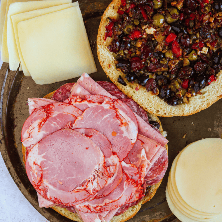 Add all of the toppings. Cheese goes on last, amazing looking sandwich.