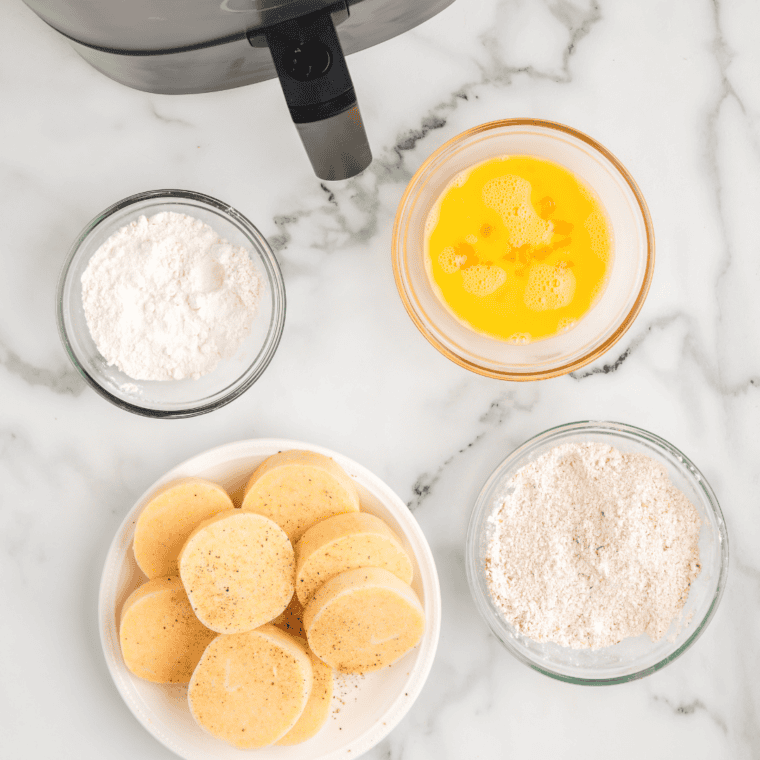 Polenta tube unwrapped, sliced into thin rounds for air frying.