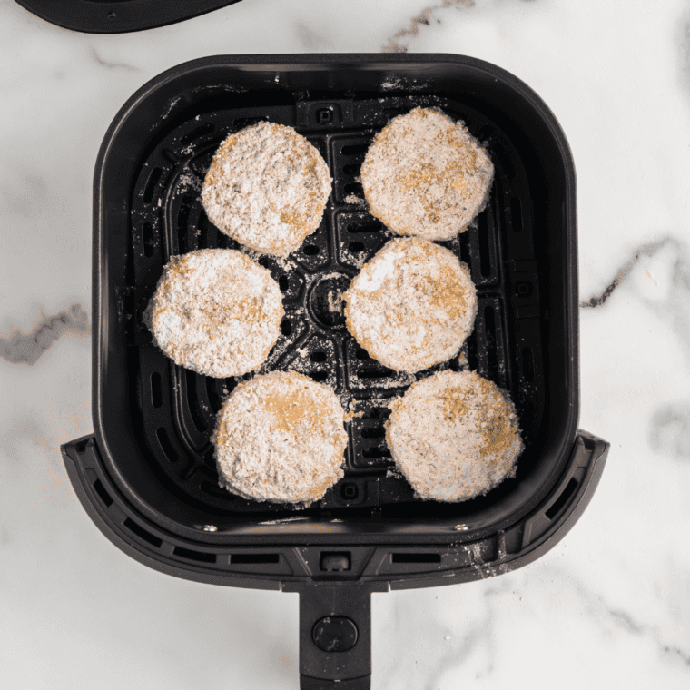 Polenta cakes air-fried until golden brown and crispy, cooling on a wire rack.
