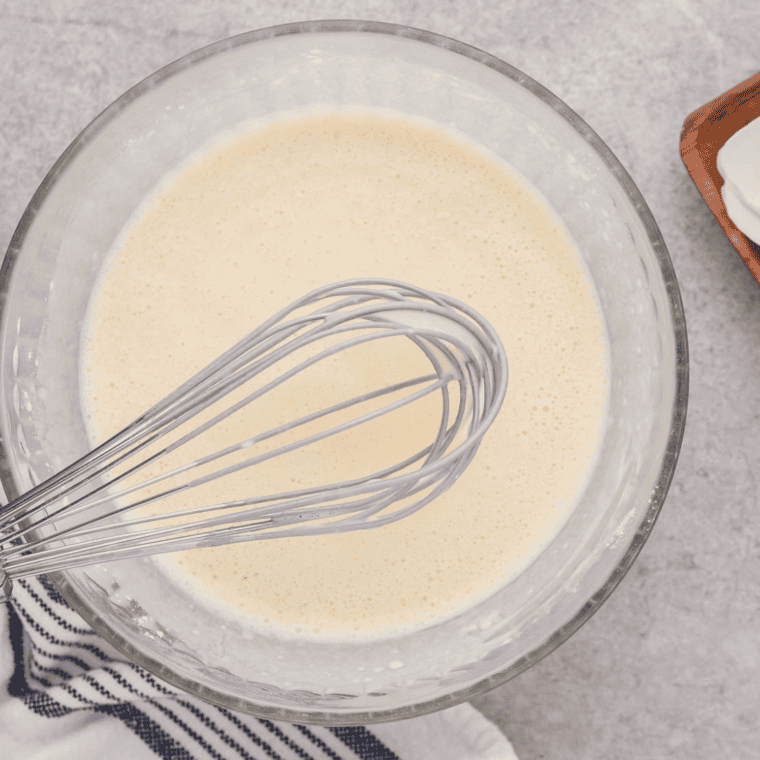 Greasing popover pan or muffin tin cups with cooking spray to prevent sticking