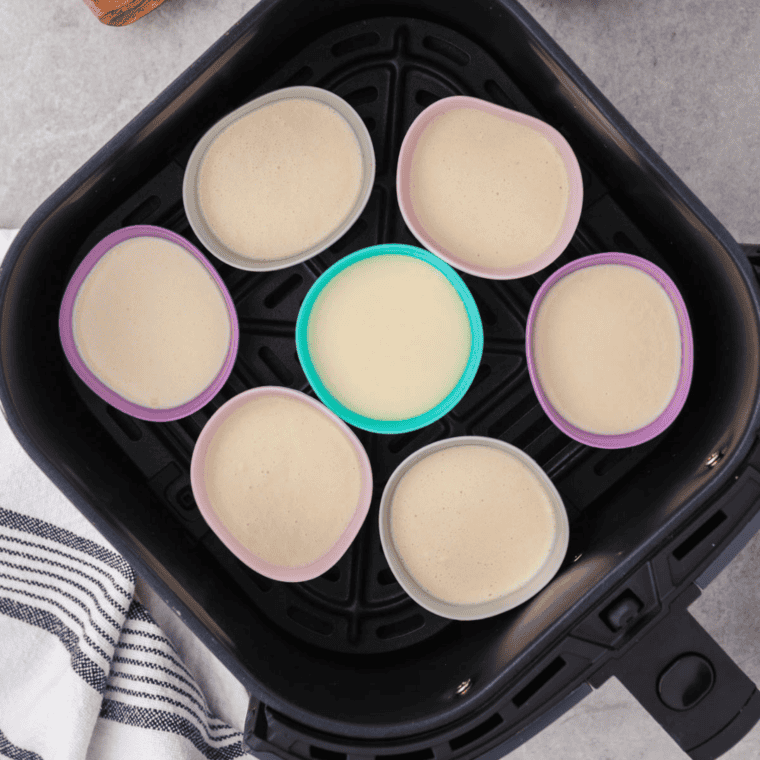 Popover pan cups filled three-quarters with batter placed in preheated air fryer basket