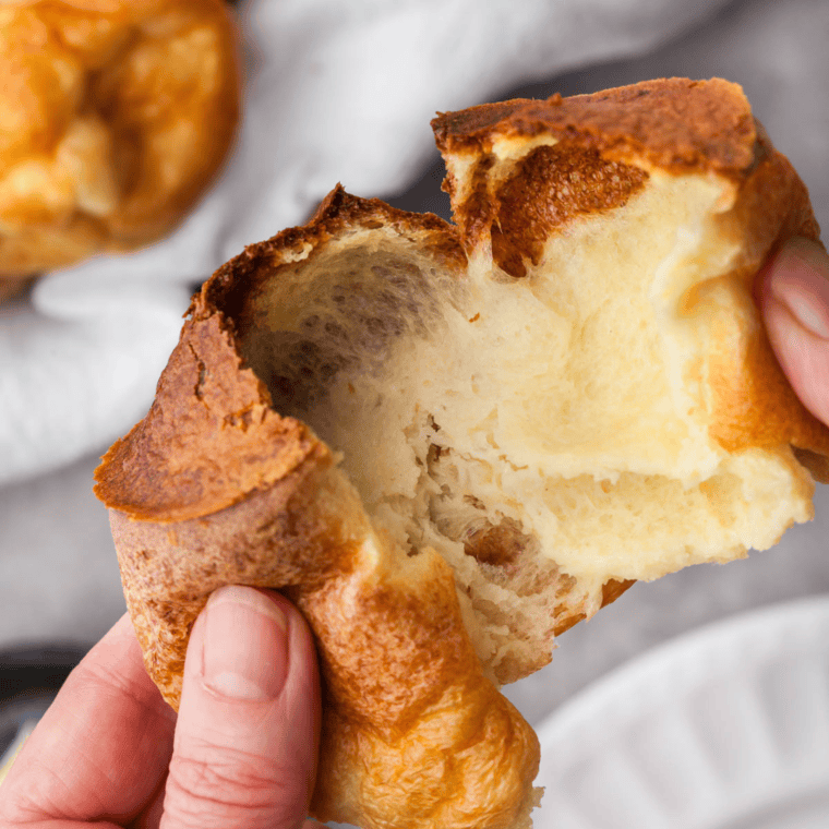 Golden, fluffy air fryer popovers puffed and freshly baked, served on a plate