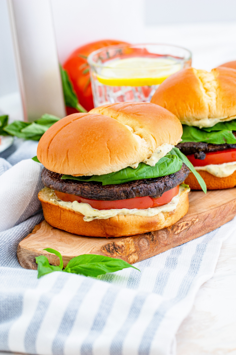 Close-up of a vegetarian Air Fryer Portobello Mushroom Burger, showcasing the garlic-marinated mushroom cap and melted cheese.