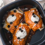 Golden crisp Enchiritos in an air fryer basket after cooking, before the red sauce and cheese are added