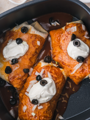 Golden crisp Enchiritos in an air fryer basket after cooking, before the red sauce and cheese are added
