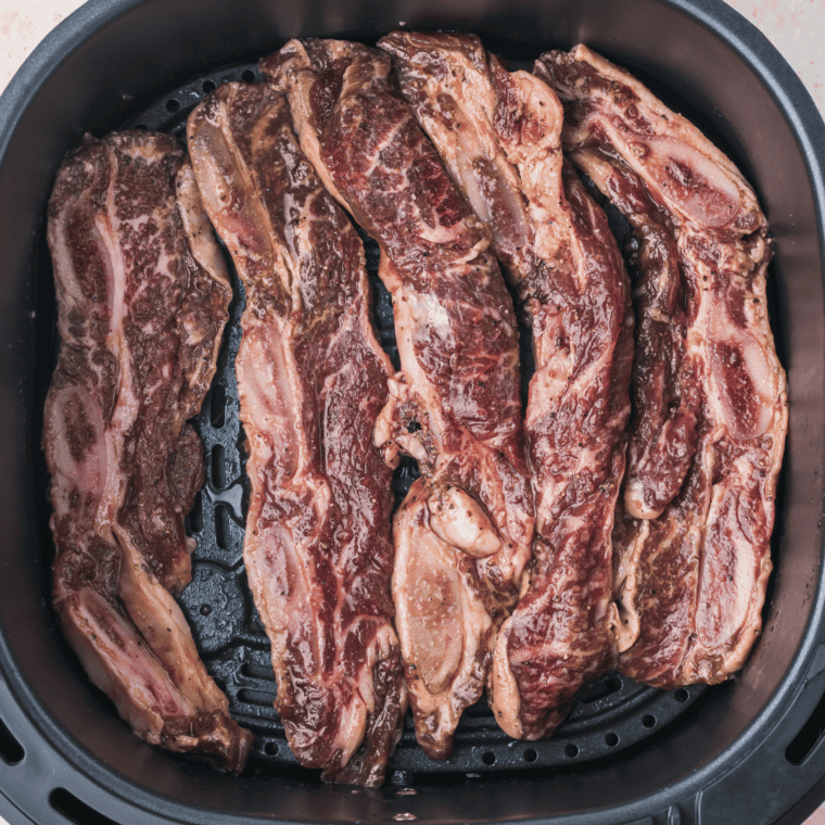 Place short ribs into the air fryer basket.