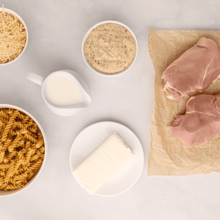 Ingredients for crockpot garlic parmesan chicken pasta: chicken, BWW sauce, cream cheese, parmesan, milk, rotini