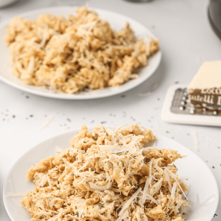 Serving of garlic parmesan chicken pasta with garlic bread on the side