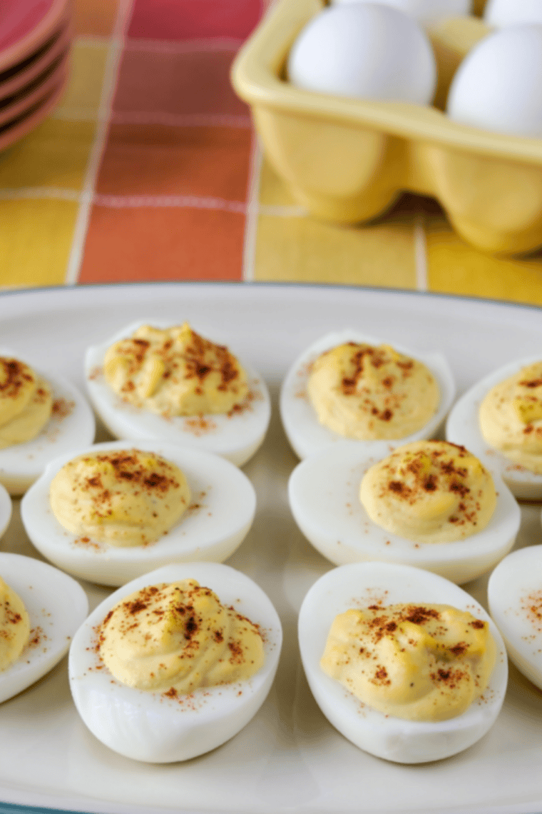 Close-up of a deviled egg without mustard topped with paprika and chives