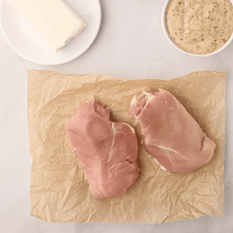 Chicken breasts, chicken broth, salt, and pepper measured out for crockpot shredded chicken.