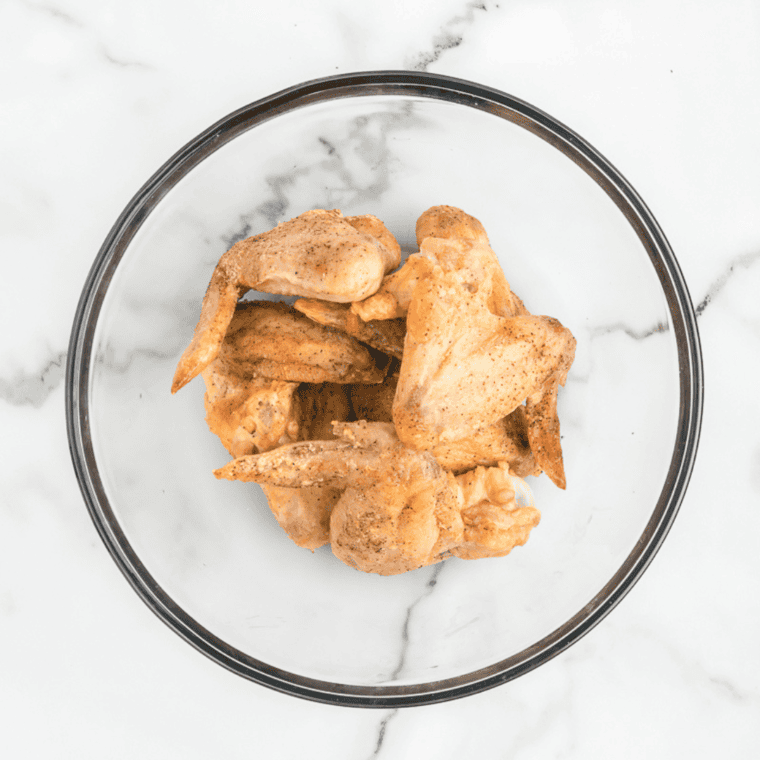 Chicken wings rinsed, dried, and coated with salt, pepper, and baking powder.