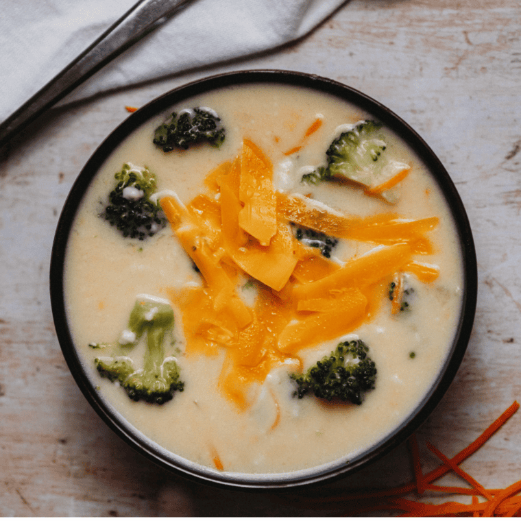 A bowl of creamy broccoli cheddar soup made in the Ninja Foodi, topped with shredded cheddar and broccoli florets.
You have not enough Humanizer words left. Upgrade your Surfer plan.