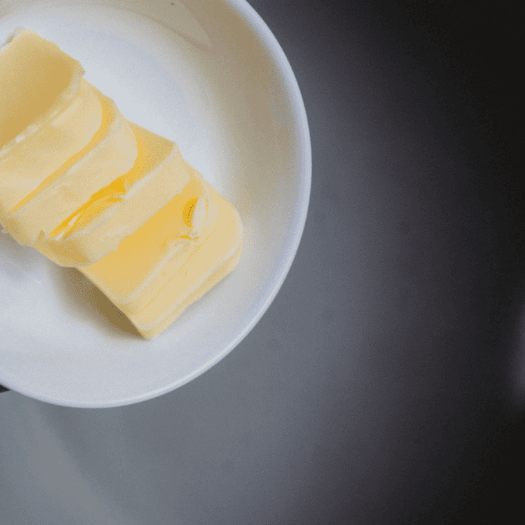 Butter melting in the Ninja Foodi insert pan on the SEAR/SAUTE setting.