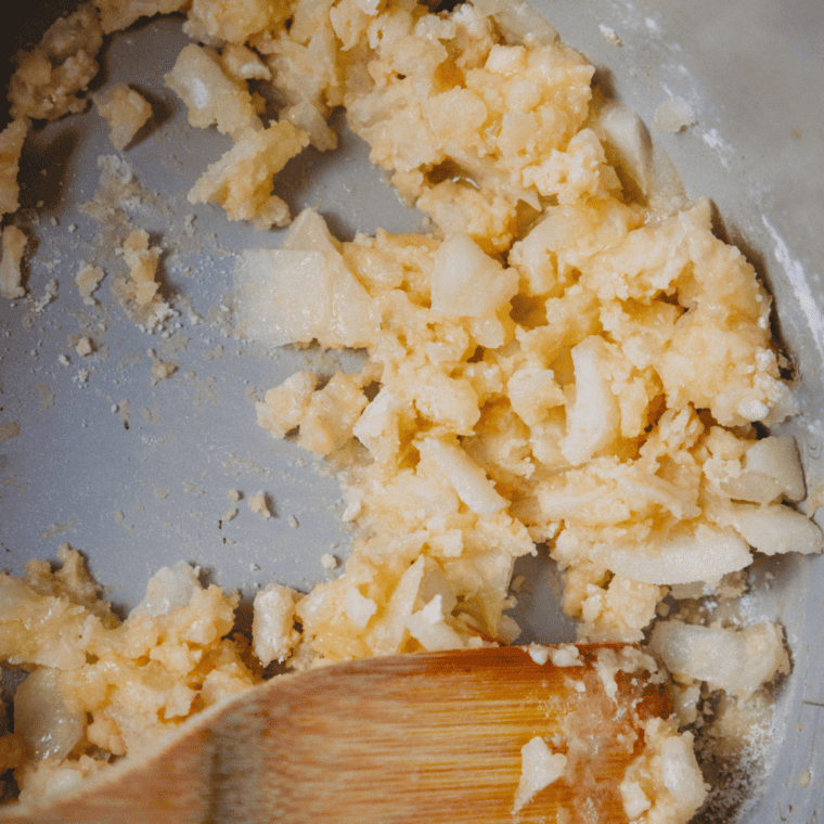 Chopped onions and minced garlic sautéing in the Ninja Foodi until translucent.