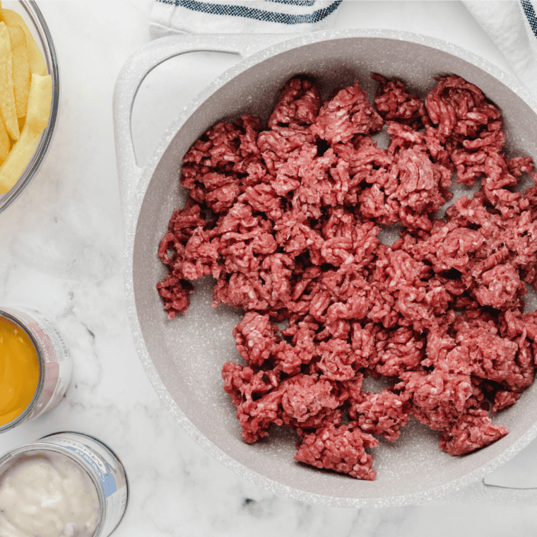 Close-up of cheesy ground beef casserole topped with crispy French fries