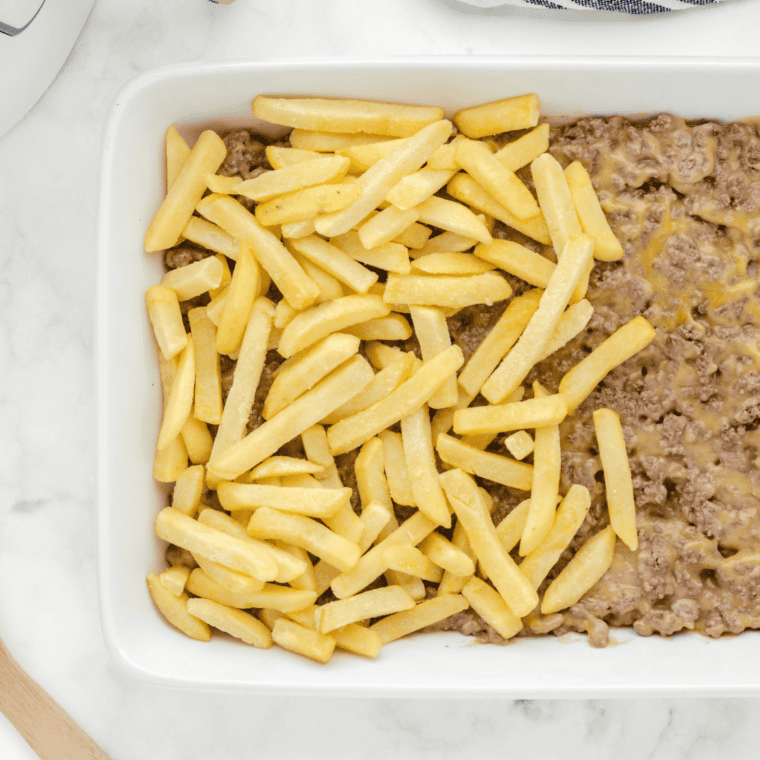 Creamy beef mixture spread evenly in a greased air-fryer-safe casserole dish