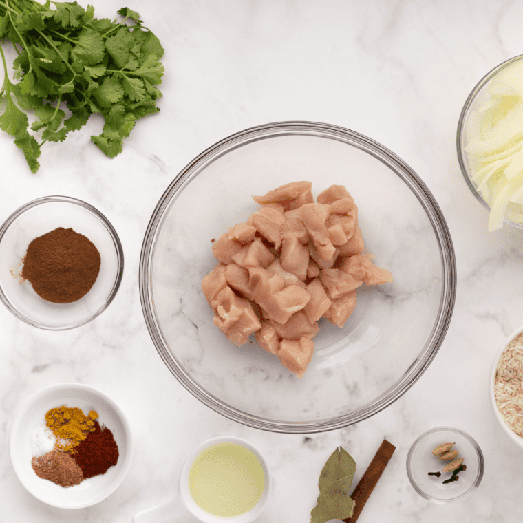 Ingredients needed for Air Fryer Chicken Biryani on kitchen table.