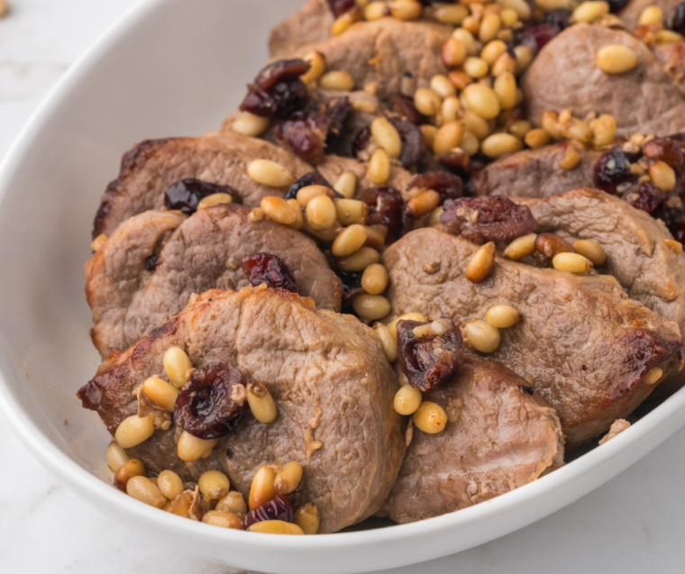 "Close-up of tender Air Fryer pork medallions served on a plate with vegetables."
