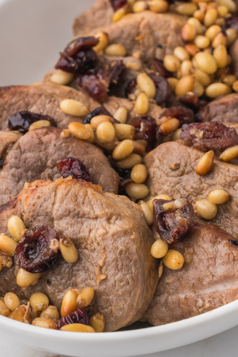 Air Fryer Pork Tenderloin Medallions Plate with dried cranberries.