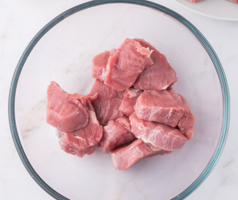 "Step-by-step guide to air frying pork medallions, starting with seasoning the meat."