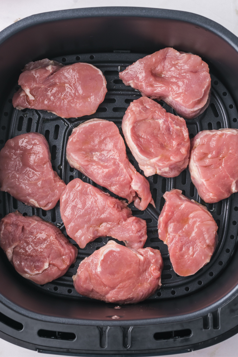 Cooking pork medallions in the air fryer until golden brown and juicy.