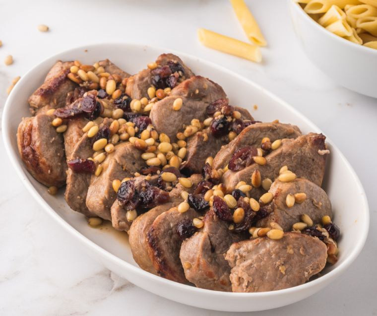 "Serving air-fried pork medallions on a plate, garnished with fresh herbs."