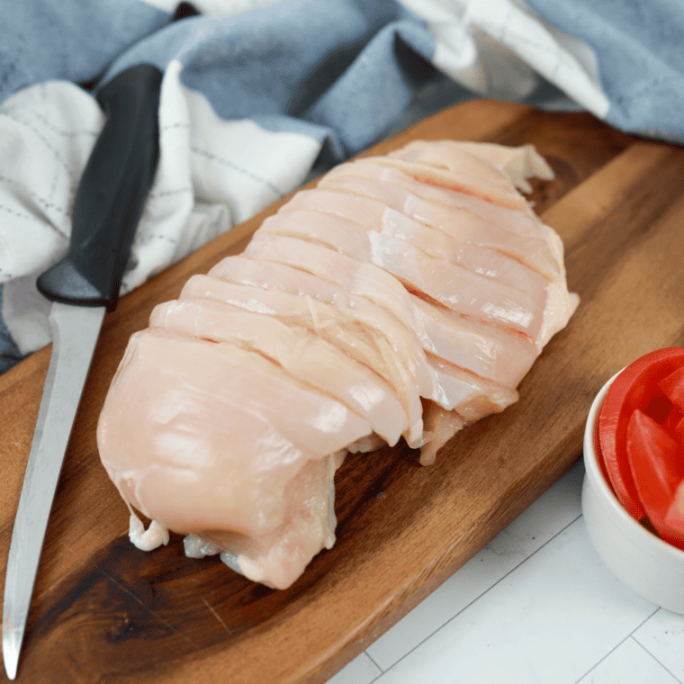 Using a sharp knife, cut the chicken into even pieces, making way for the filling.