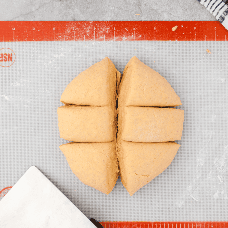 Shaping the pumpkin bagel dough into rings, preparing them for the air fryer