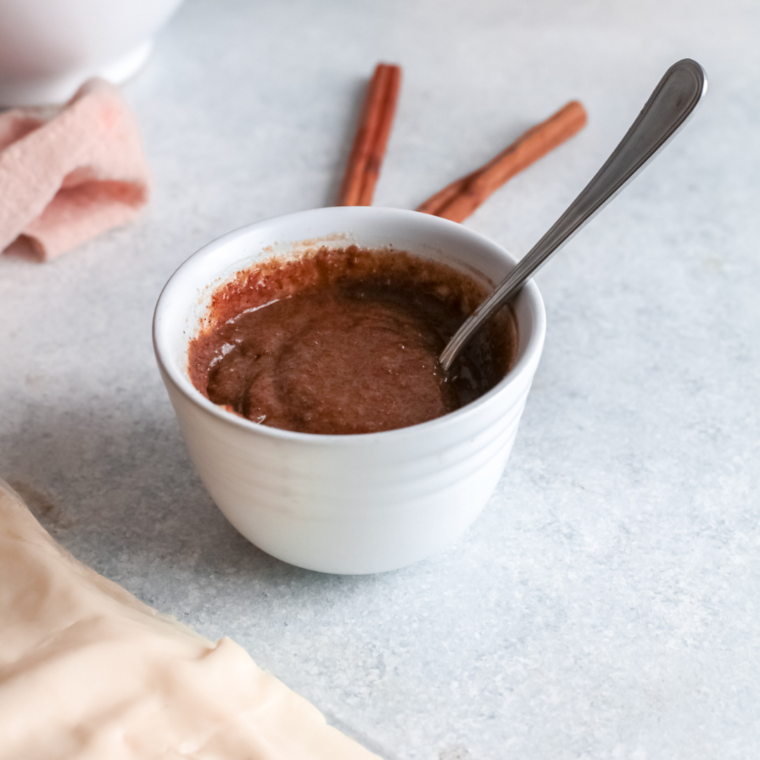 Mixing butter, brown sugar, and pumpkin pie spice together in a bowl.