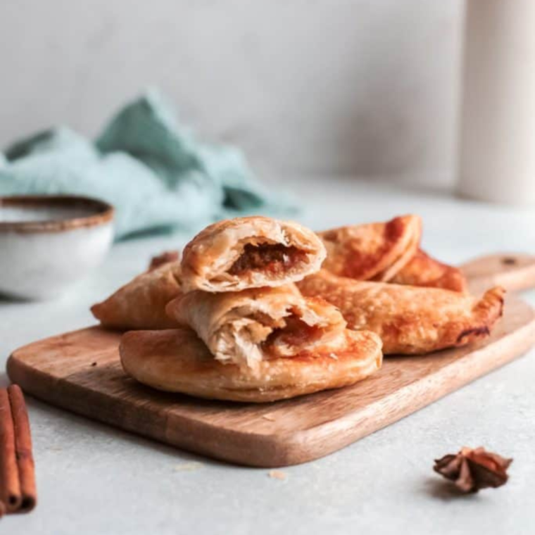 Golden Air Fryer Pumpkin Hand Pies with flaky crusts and spiced pumpkin filling, arranged on a serving plate.