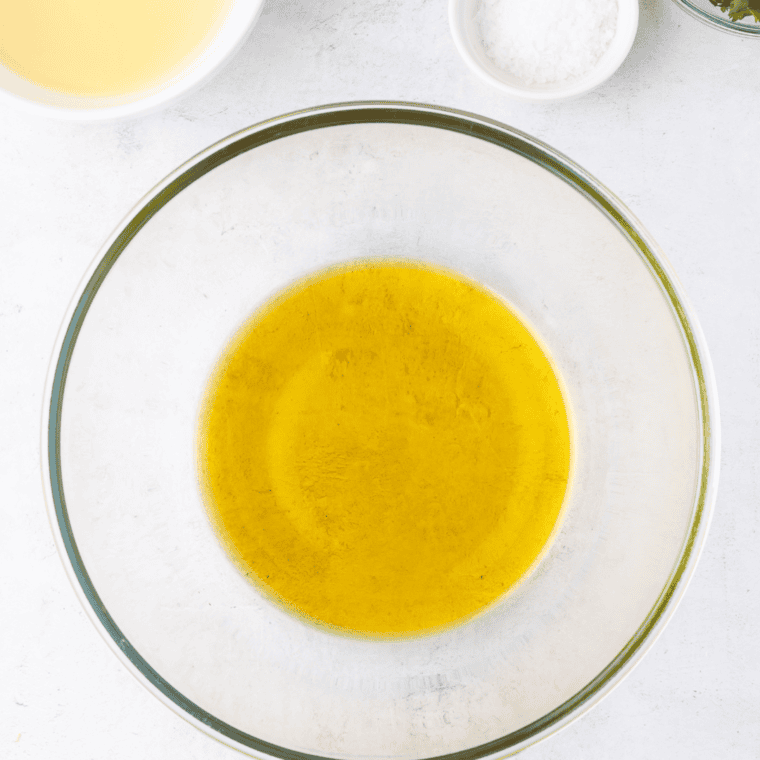 Marinade preparation: olive oil, lime juice, minced garlic, Kosher salt, and fresh cilantro mixed in a large bowl.