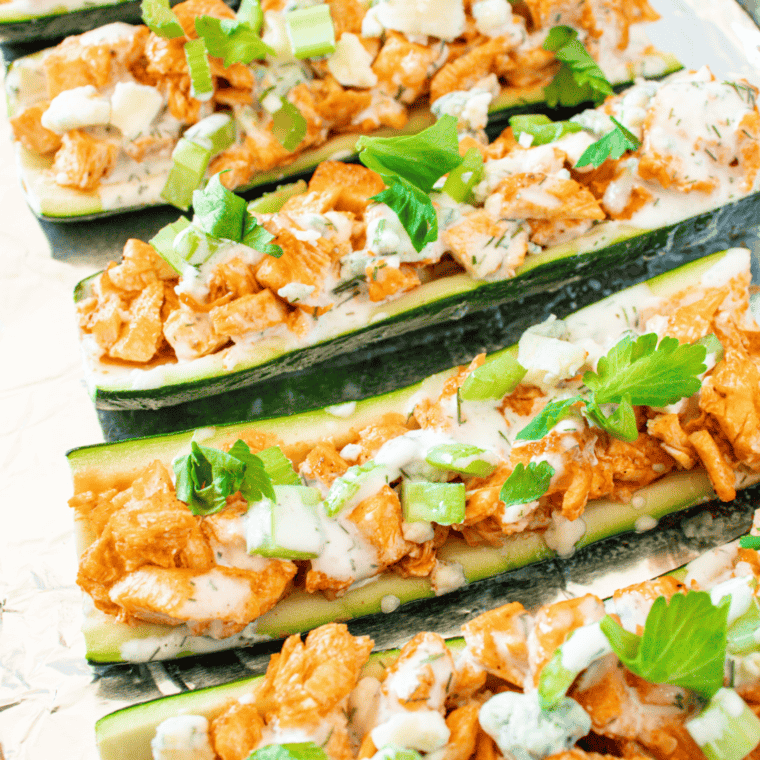 A platter of Air Fryer Zucchini Boats with various toppings, ready to serve at a summer barbecue.