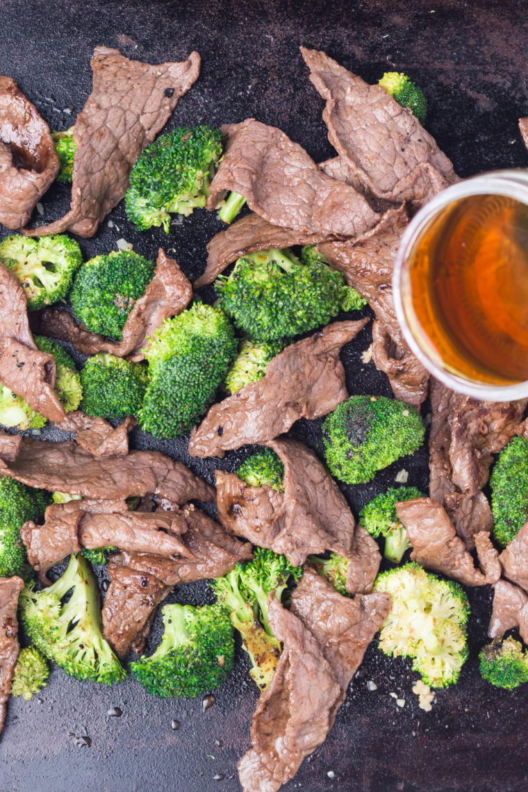 Fresh broccoli florets cooking on a Blackstone griddle with light seasoning