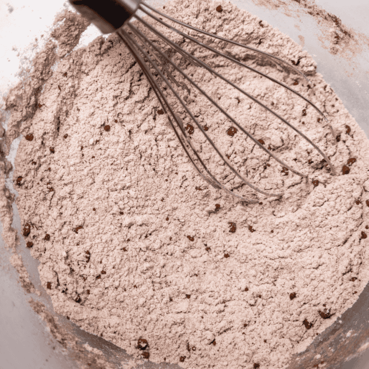 Dry pancake ingredients whisked together in a large mixing bowl for even, lump-free batter