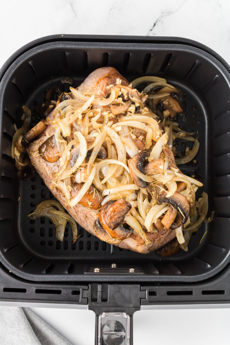 Place the pot roast into the air fryer basket and add the topping.