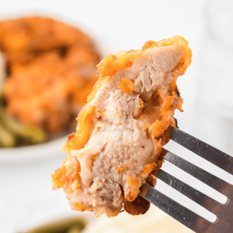 A plate of crispy Cracker Barrel Southern Fried Chicken, showcasing its golden brown exterior and juicy meat, served with classic sides for a hearty meal.