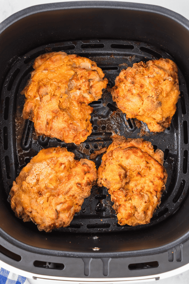 "Golden brown Air Fryer Cracker Barrel Southern Fried Chicken pieces resting on a cooling rack after cooking."