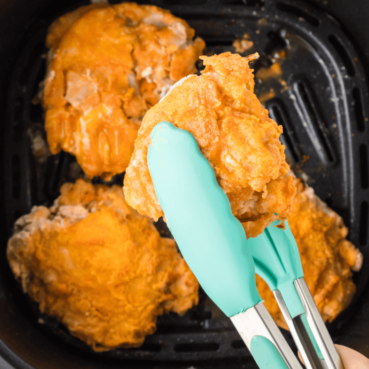 Golden brown Air Fryer Cracker Barrel Southern Fried Chicken pieces resting on a cooling rack after cooking.