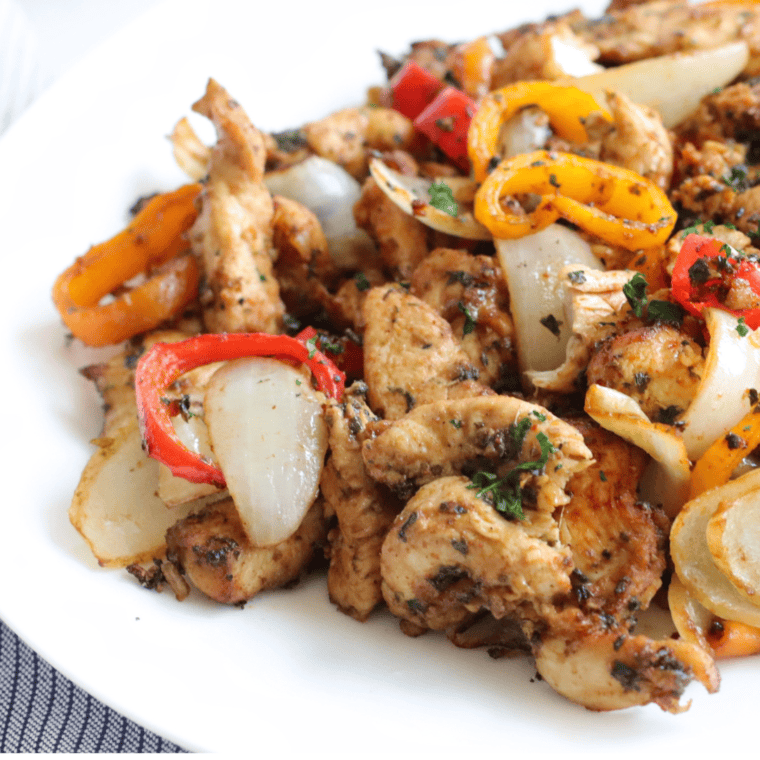 Close-up of juicy Ninja Foodi chicken fajitas with golden peppers and caramelized onions