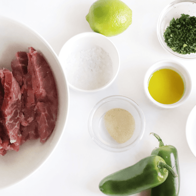 Ingredients needed for Easy Ninja Foodi Grill Steak Fajitas on kitchen table.