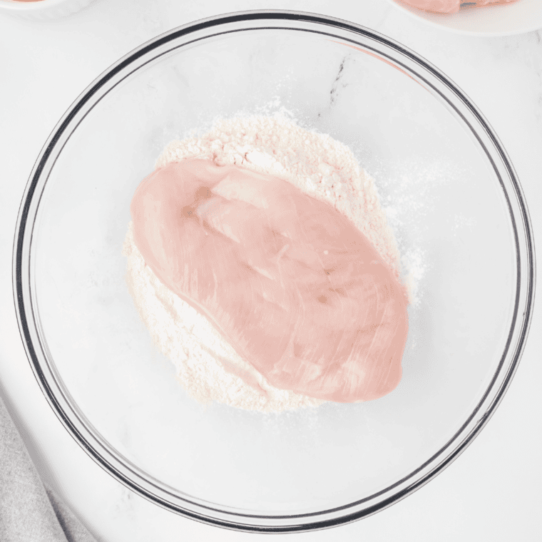 Seasoning chicken breasts for Olive Garden Chicken Scampi recipe.