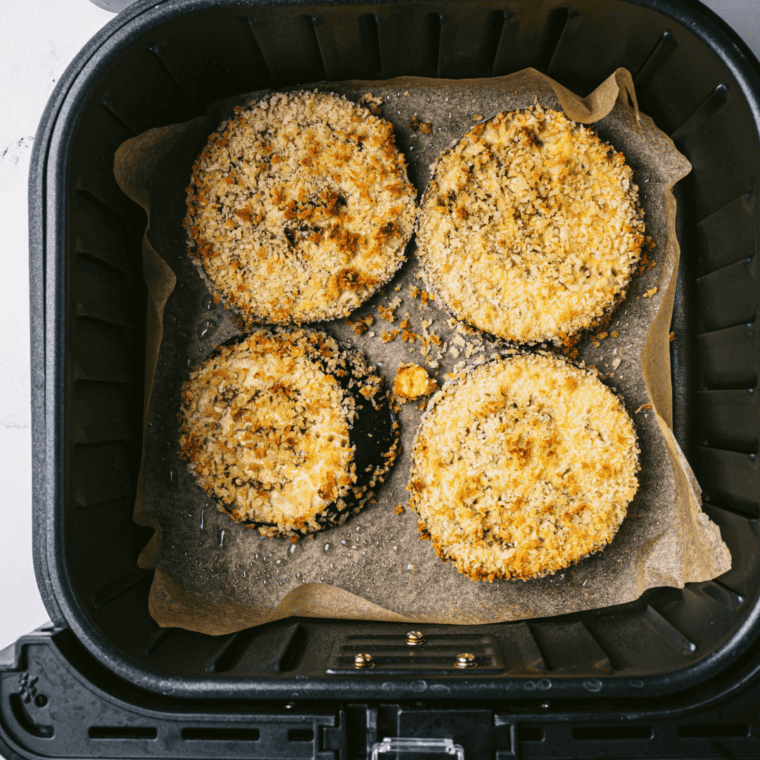 Layering fried eggplant, marinara sauce, and cheese in a baking dish for Olive Garden's Eggplant Parmesan.