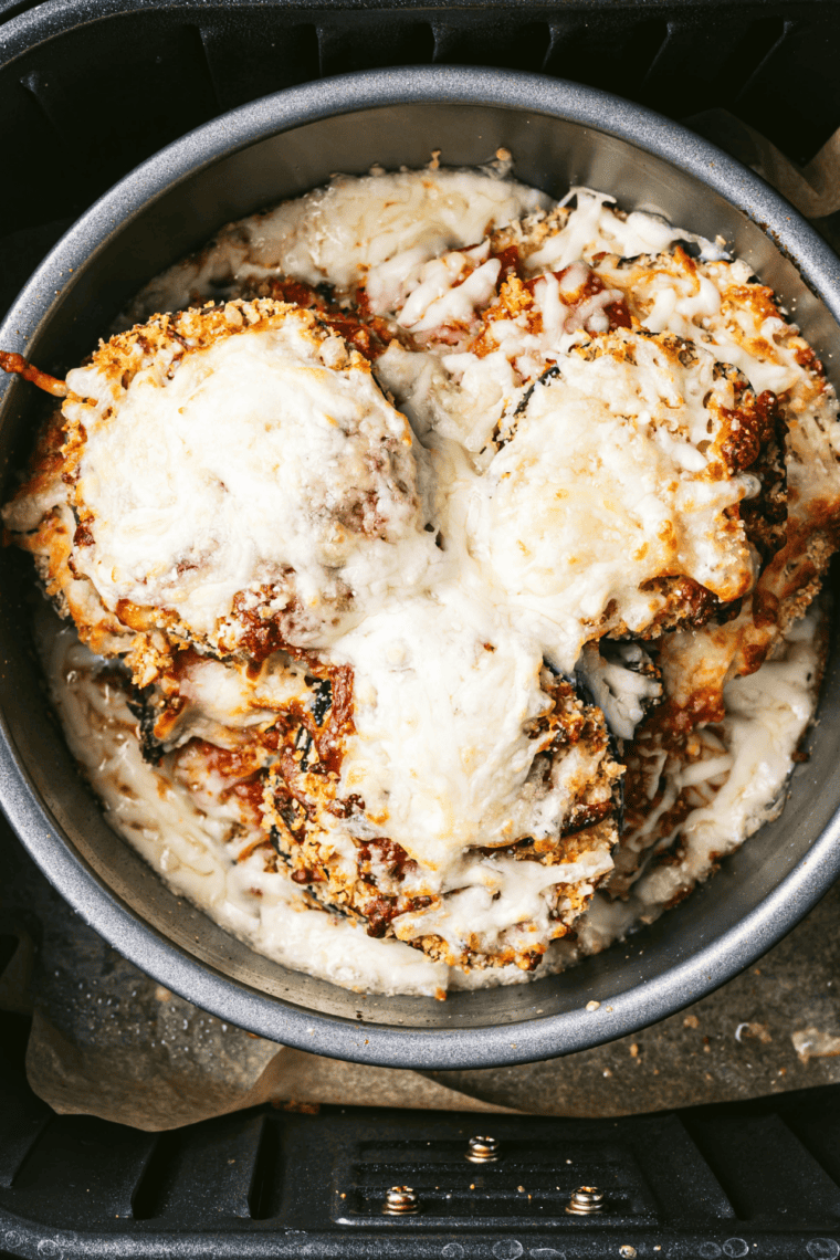Baking Olive Garden's Eggplant Parmesan until bubbly and golden on top.