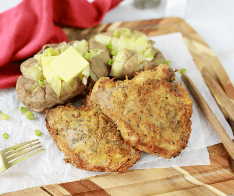 Juicy pork chops being reheated in an air fryer basket