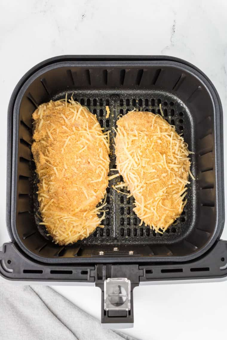 Place the coated chicken breast into the air fryer basket.