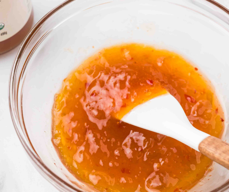Apricot preserves, sweet and sour sauce, and rice vinegar whisked into a glaze in a glass bowl