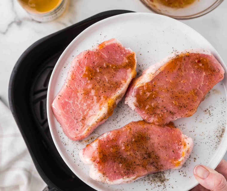 Boneless pork chops marinating in apricot glaze before air frying