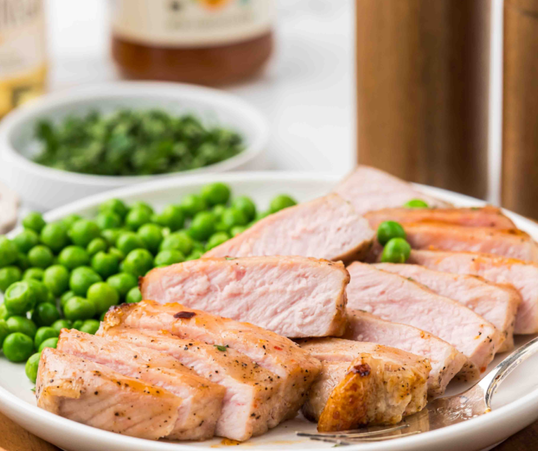 Two apricot-glazed pork chops fresh from the air fryer, ready to serve