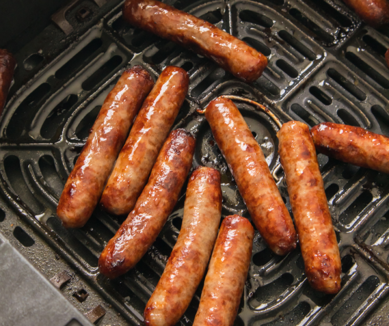 Air Fryer Johnsonville Breakfast Sausage links sizzling in the air fryer basket.